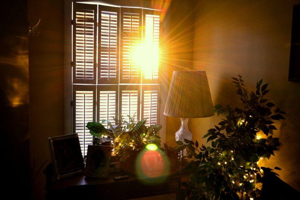 Early morning light streaming through the shutters